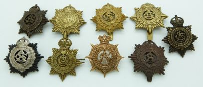 Nine British Army, Army Service Corps metal cap badges including a non voided example