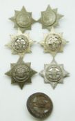 Seven British Army 4th/7th Dragoon Guards metal collar badges including a silver voided example.