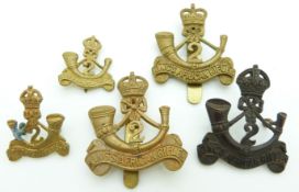 Five 2nd King's African Rifles metal badges including an officer's example and two collar badges