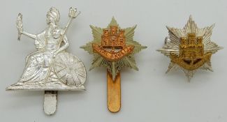 Three British Army Royal Anglian Regiment metal cap badges including officer's small gilt cap