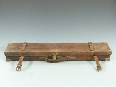 Two shotgun cases, one wooden for a muzzle loading gun with fitted interior, the other brass bound