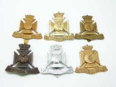 Six British Army The Wiltshire Regiment metal cap badges including an 1950s pattern