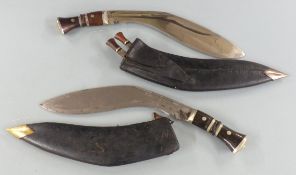 Two kukris in scabbard, one marked to blade The Army Traders India, length of longer 45cm