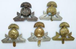 Five British Army Lancashire Fusiliers metal cap badges including an all brass example