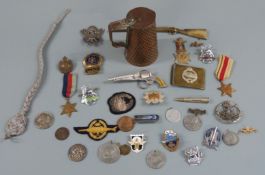 Quantity of mainly British military insignia and medals including Africa and 1939-45 Stars,