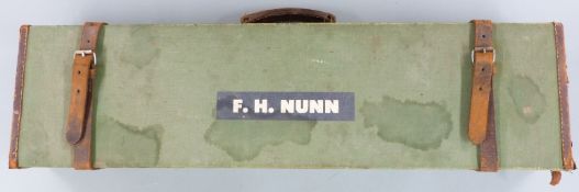 A vintage leather and canvas shotgun case with fitted interior 82x22x10cm.