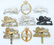 Nine British Army King's Own Regiment metal badges including a facing pair worn by tank units WWII