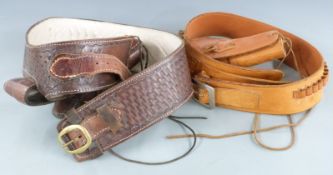 Two leather ammunition belts each with matching holsters and dummy ammunition.