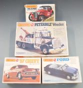 Four Matchbox AMT 1:25 scale plastic model kits comprising Peterbilt Wrecker PK-6110, '57 Chevy PK-