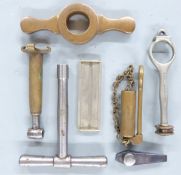 Seven gun or shooting related tools including James Dixon & Sons 1137B and similar shotgun cartridge