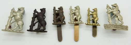 Six British Army Warwickshire Yeomanry metal badges including an Imperial Yeomanry and white metal