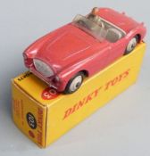 Dinky Toys diecast model Austin-Healey '100' Sports with red body and grey interior, hubs and
