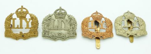 Four British Army Leicestershire Yeomanry cap badges including an Imperial Yeomanry non voided