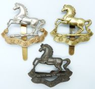 Three British Army King's Liverpool Regiment metal hat badges including an all brass example