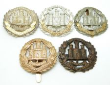 Five British Army Northamptonshire Regiment metal cap badges including an all brass example