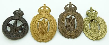 Four British Army Westmoreland and Cumbrian Yeomanry metal cap badges including an officer's