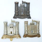 Three British Army 6th Inniskilling Dragoon metal cap badges