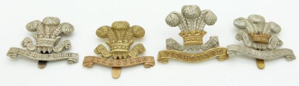 Four British Army Pembrokeshire Yeomanry metal cap badges including an officer's example