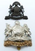 Two British Army Manchester Regiment metal hat badges including an officer's service dress example