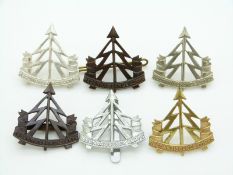 Six British Army Reconnaissance Corps metal cap badges including an officer's white metal and bronze