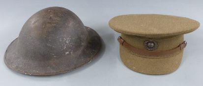 Royal Marines cap together with a 'Brodie' steel helmet with red and white painted logo