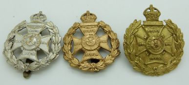 Three British Army 17th County of London Battalion Poplar and Stepney Rifles metal cap badges