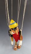 A large painted wooden Pinocchio puppet, possibly ex shop display, 56cm tall.