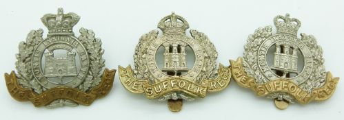 Three British Army Suffolk Regiment metal cap badges including a two tone Victorian crown example