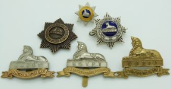 Six British Army Lincolnshire Regiment metal cap badges including an officer's gilt and enamel