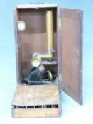 Cased 19th or early 20th century microscope together with a case of approximately 40 slides