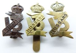 Three British Army 13th Hussars metal cap badges
