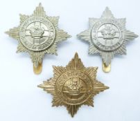 Three British Army 4th/7th Dragoon Guards metal cap badges