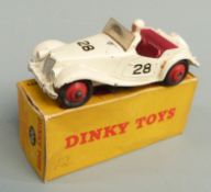 Dinky Toys diecast model M.G. Midget Sports with cream body, red interior and hubs, white driver and