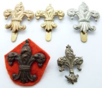 Five British Army Manchester Regiment 7th Battalion metal badges including a bronze example