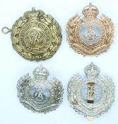 Four British Army Royal Engineers Volunteers metal badges including a Queen Victoria cipher example