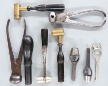 Nine gun or shooting tools and accessories including powder measures, wad punches, bullet moulds,