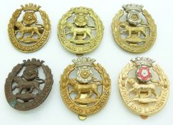 Six British Army York and Lancaster Regiment metal cap badges including an all brass and officer's