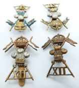 Four British Army 12th Lancers metal cap badges including example by Gaunt