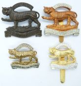 British Army Royal Leicestershire Regiment metal badges including a bronze example with blades