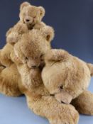 A family of three Hermann Original bears lying down, largest 100cm long, all with original labels