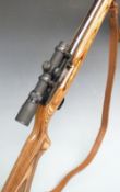 Ruger model 10/22 .22LR semi-automatic carbine rifle with show wood stock, semi-pistol grip, leather