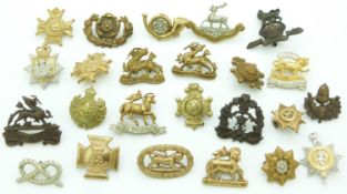 Small collection of British Army metal badges including Royal West Kent Regiment, Queen's, Royal