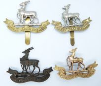 Four British Army Royal Warwickshire Regiment metal hat badges