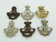 Six British Army Queen's Own Oxfordshire Hussars metal cap badges including brass and bronze