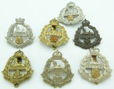 Seven British Army East Lancashire Regiment metal cap badges including all brass and Victorian other