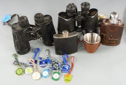 Two pairs of binoculars, one by Pancrama 10x50, the other 7x50, with paper and enamel racecourse