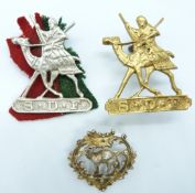Two Sudan Defence Force metal hat badges together with a pin back brooch