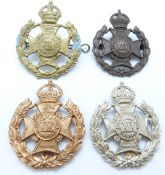 Four British Army 19th County of London Battalion St Pancras metal cap badges, one with correct date