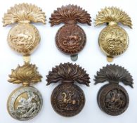Six British Army Northumberland Fusiliers metal cap badges