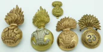 Five British Army Royal Welsh Fusiliers metal hat badges including a Glangarry example
